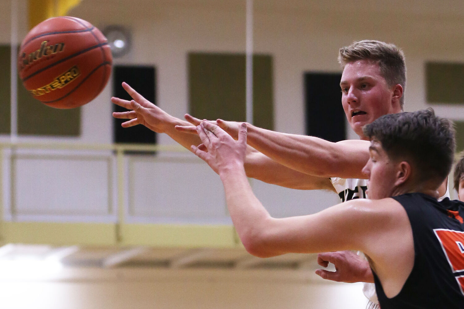 Hyrum Hatch passes the ball to a teammate despite the defense of Burns